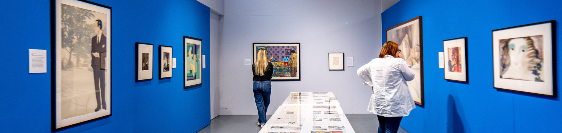 People in an art gallery with bright blue walls